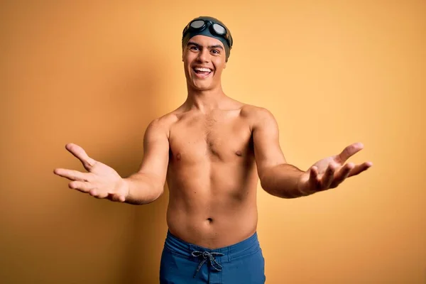 Young Handsome Man Shirtless Wearing Swimsuit Swim Cap Isolated Yellow — Stock Photo, Image