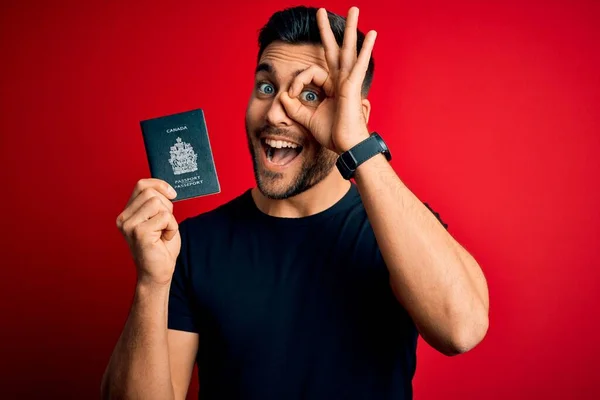 Young Handsome Tourist Man Holding Canada Canadian Passport Red Background — Stock Photo, Image