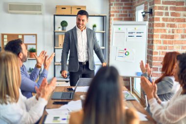 Group of business workers working together in a meeting. One of them making presentation to colleagues at the office