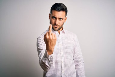 Young handsome man wearing elegant shirt standing over isolated white background Showing middle finger, impolite and rude fuck off expression