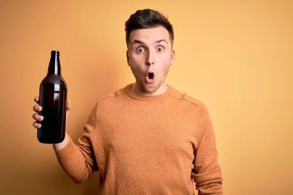 Ung Stilig Kaukasisk Man Dricker Flaska Över Gul Bakgrund Rädd — Stockfoto