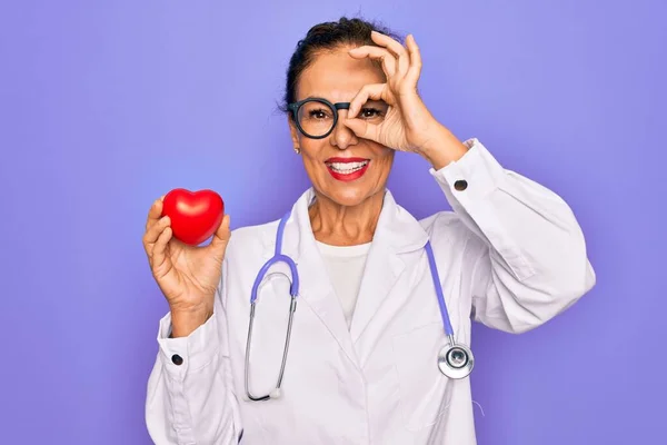 Middle Age Senior Cardiologist Doctor Woman Holding Red Heart Purple — Stock Photo, Image