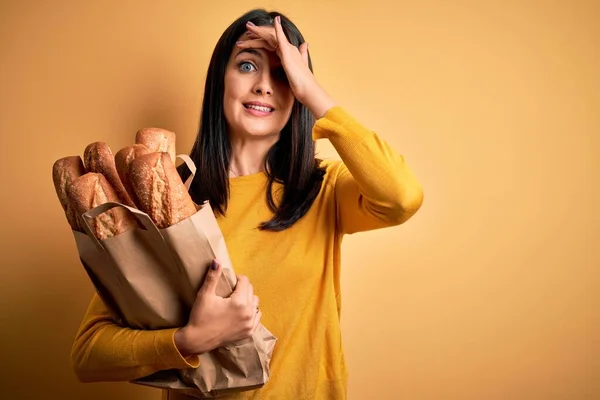 Young Woman Blue Eyes Holding Paper Bag Bread Isolated Yellow — Stock Photo, Image