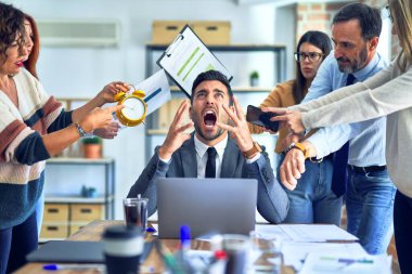 Group of business workers working together. Partners stressing one of them at the office