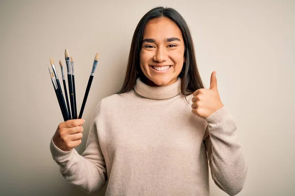 Joven Hermosa Artista Asiática Mujer Sosteniendo Pinceles Pie Sobre Fondo —  Fotos de Stock