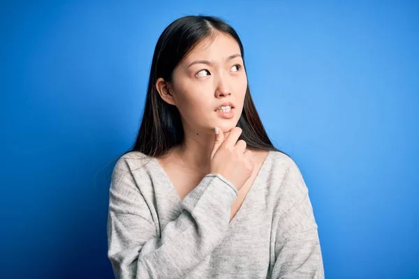 Junge Schöne Asiatische Frau Lässigem Pullover Vor Blauem Hintergrund Besorgt — Stockfoto