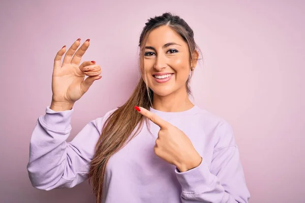 Joven Hermosa Mujer Comiendo Pastelería Francesa Dulce Macaron Sobre Rosa — Foto de Stock