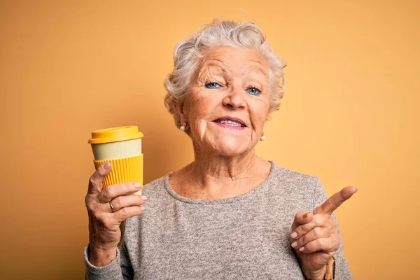Starsza Piękna Kobieta Pije Kawę Stojąc Nad Odizolowanym Żółtym Tłem — Zdjęcie stockowe