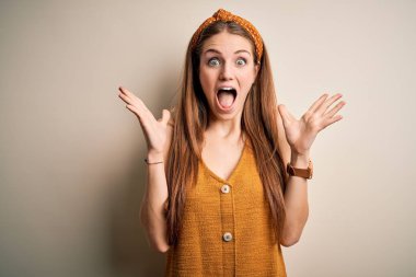 Sarı arka plan üzerine gündelik tişört ve diyabet giyen genç, güzel, kızıl saçlı bir kadın çılgın ve başarıyı kollarını kaldırıp heyecanla haykırarak kutluyor. Kazanan konsept