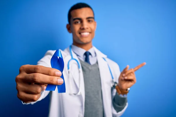 Jovem Homem Médico Afro Americano Bonito Segurando Símbolo Fita Azul — Fotografia de Stock