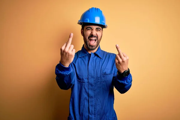 Mechanic Man Beard Wearing Blue Uniform Safety Helmet Yellow Background — Zdjęcie stockowe