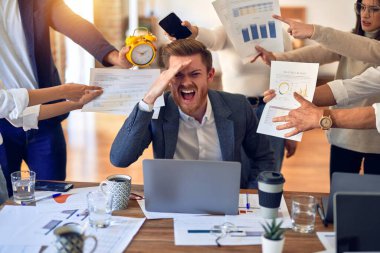 Group of business workers working together. Partners stressing one of them at the office