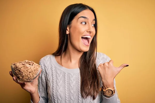 Young Beautiful Brunette Woman Holding Bowl Healthy Cornflakes Cereals Pointing — Stockfoto