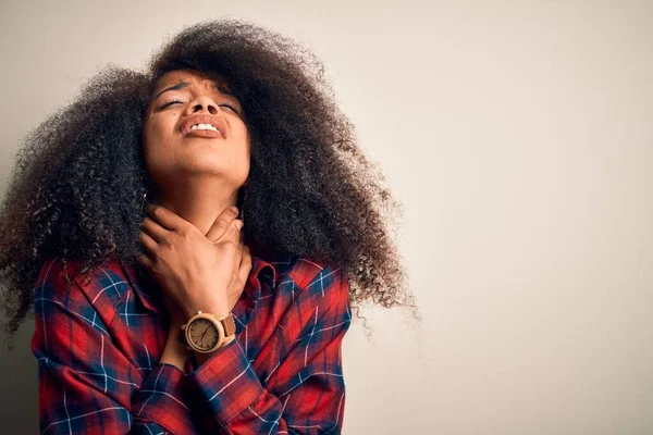 Young beautiful african american woman wearing casual shirt over isolated background shouting and suffocate because painful strangle. Health problem. Asphyxiate and suicide concept.