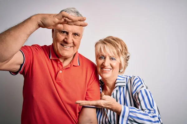 一对年轻貌美的老夫妇站在孤零零的白色背景上 手拿着大号和大号的手势 测量符号 笑着看着摄像机 计量概念 — 图库照片