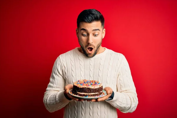 Young Handsome Man Holding Colorful Birthday Sweet Cake Red Isolated — Stock Photo, Image
