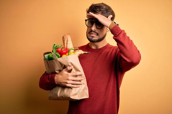 Young Man Wearing Glasses Holding Paper Bag Food Isolated Yellow — Stock Photo, Image