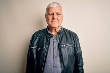 Yüzünde ciddi bir ifadeyle izole edilmiş beyaz arka plan üzerine günlük gömlek ve ceket giyen kıdemli yakışıklı beyaz adam. Basit ve doğal bir şekilde kameraya bakıyorsun..
