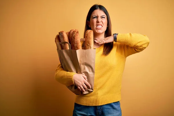 Young Beautiful Woman Holding Bag Fresh Healthy Bread Yellow Background — Stock Photo, Image