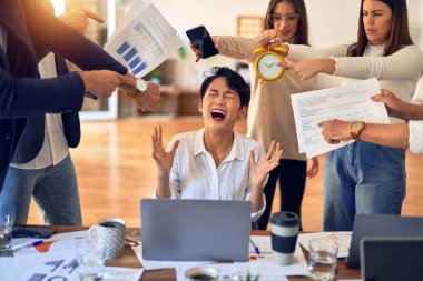 Group of business workers working together. Partners stressing one of them at the office