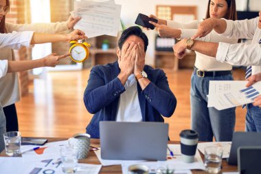 Group of business workers working together. Partners stressing one of them at the office