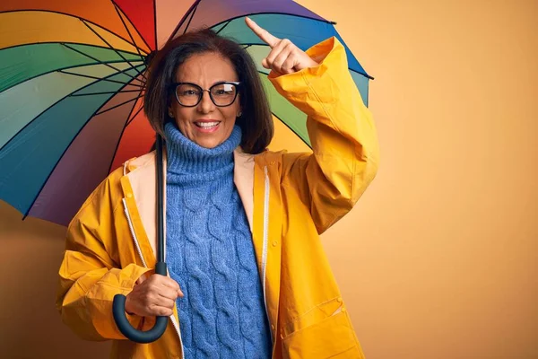 Frau Mittleren Alters Gelbem Regenmantel Unter Buntem Regenschirm Über Isoliertem — Stockfoto