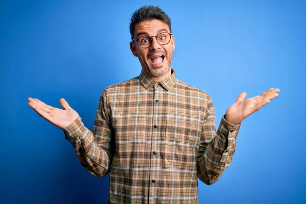 Mladý Pohledný Muž Neformální Košili Brýlích Stojící Nad Modrým Pozadím — Stock fotografie