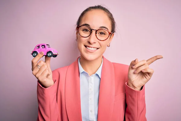 Jovem Mulher Negócios Bonita Usando Óculos Segurando Brinquedo Carro Rosa — Fotografia de Stock