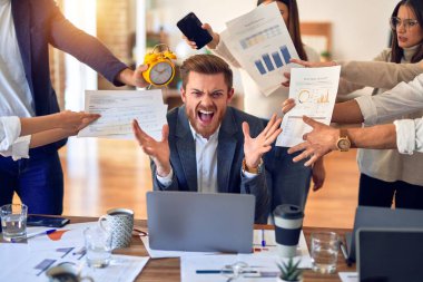 Group of business workers working together. Partners stressing one of them at the office