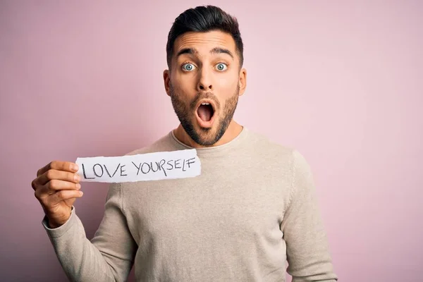 Young Handsome Man Holding Paper Self Love Message Pink Background — Stock Photo, Image