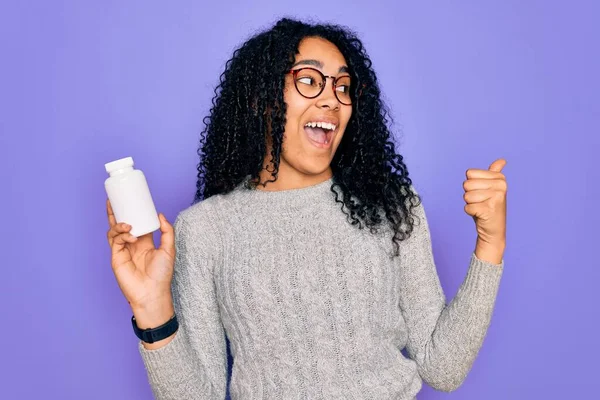 Jovem Afro Americana Encaracolado Mulher Segurando Pílulas Sobre Fundo Roxo — Fotografia de Stock