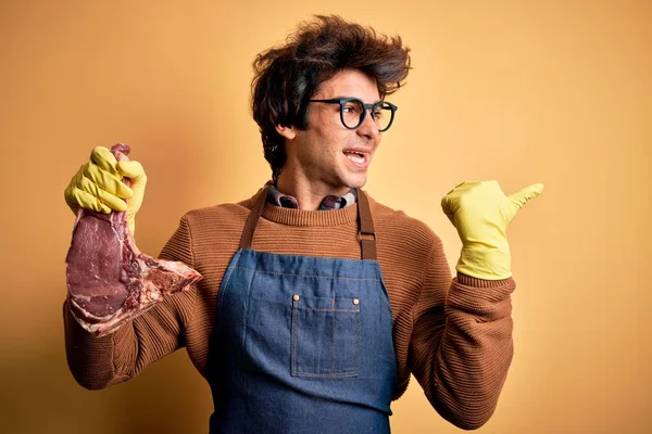 Jovem Bonito Açougueiro Homem Segurando Atender Bife Sobre Isolado Amarelo — Fotografia de Stock