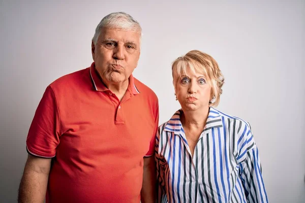 Senior Beautiful Couple Standing Together Isolated White Background Puffing Cheeks — Stock Photo, Image