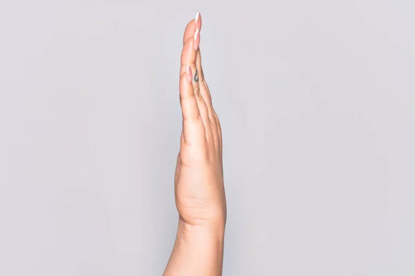 Hand of caucasian young woman showing side of stretched hand, pushing and doing stop gesture