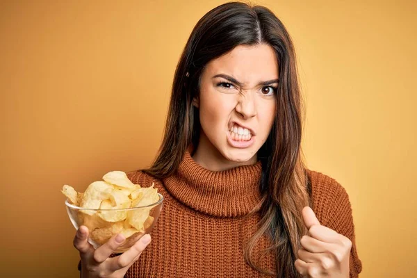 Young Beautiful Girl Holding Bowl Chips Potatoes Standing Yellow Background — Stock Photo, Image