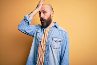 Sakallı, sıradan bir kot ceket ve çizgili tişört giyen yakışıklı, kel bir adam. Yanlışlıkla el ele tutuşan bir tişört. Hatayı hatırla. Unuttum, kötü hafıza konsepti.