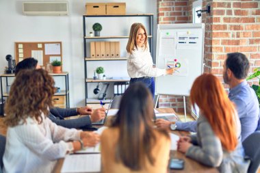 Group of business workers working together in a meeting. One of them making presentation to colleagues at the office