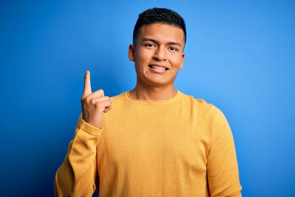 Young Handsome Latin Man Wearing Yellow Casual Sweater Isolated Blue — Stock Photo, Image