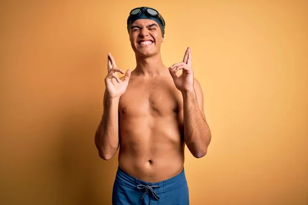 Young Handsome Man Shirtless Wearing Swimsuit Swim Cap Isolated Yellow — Stock Photo, Image