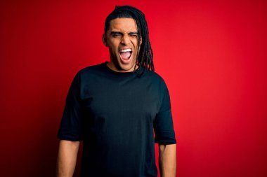 Rastgele tişört giyen, kameraya seksi bir ifadeyle bakan, neşeli ve mutlu yüzlü Afro-Amerikan genç adam..