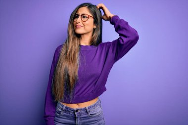 Mor izole edilmiş arka planda gözlük takan güzel ve zeki bir kadın soru sormayı merak ediyor. Şüpheyle kararsız, kafa kafaya düşünerek. Düşünceli kavram.