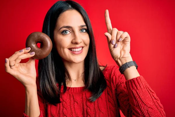 Joven Morena Ojos Azules Comiendo Rosquilla Chocolate Sobre Fondo Rojo —  Fotos de Stock