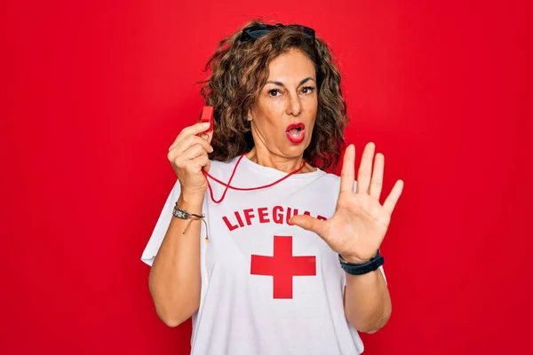 Middle Age Senior Summer Lifeguard Woman Holding Whistle Red Background — Φωτογραφία Αρχείου