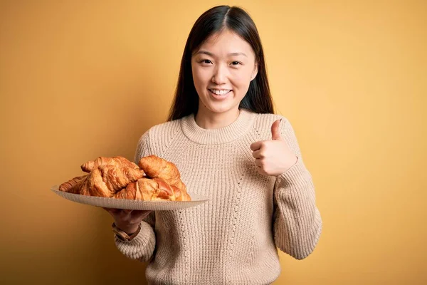 Joven Mujer Asiática Sosteniendo Croissant Pastelería Francesa Sobre Fondo Aislado — Foto de Stock