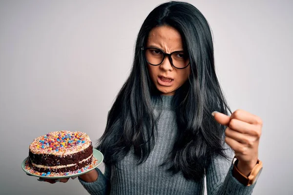 若い美しい中国人女性保持誕生日ケーキ立って上の隔離された白い背景いらいらし 怒りで叫んで 狂気と大声で手を上げ 怒りの概念 — ストック写真