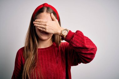 Genç, kızıl saçlı, kırmızı süveter giyen ve sarı arka planda çapraz çizgili gülümseyen ve yüzünde şaşkınlıktan gözleri gören güzel bir kadın. Kör kavram.