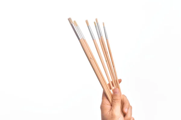 Hand Caucasian Young Man Holding Paintbrushes Isolated White Background — Stock Photo, Image