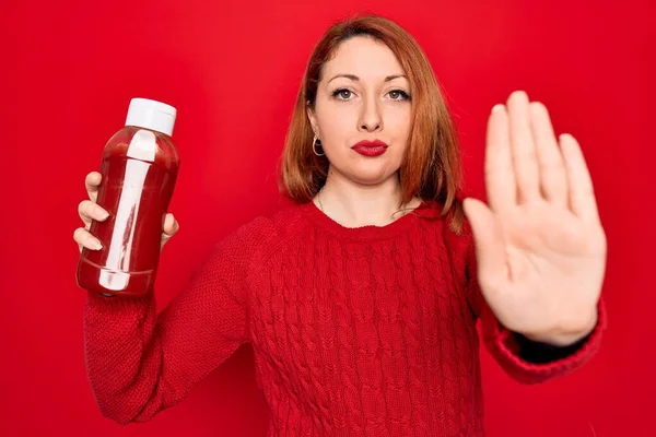 Beautiful Redhead Woman Holding Bottle Ketchup Sauce Condiment Red Background — Stock Photo, Image