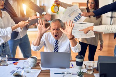 Group of business workers working together. Partners stressing one of them at the office
