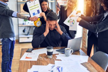 Group of business workers working together. Partners stressing one of them at the office